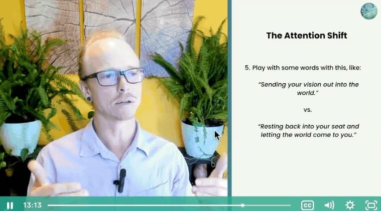 A frame from Week 3: Asa Dean speaking with both hands raised beside a slide titled The Attention Shift, contrasting sending your vision out into the world with resting back into your seat and letting the world come to you.