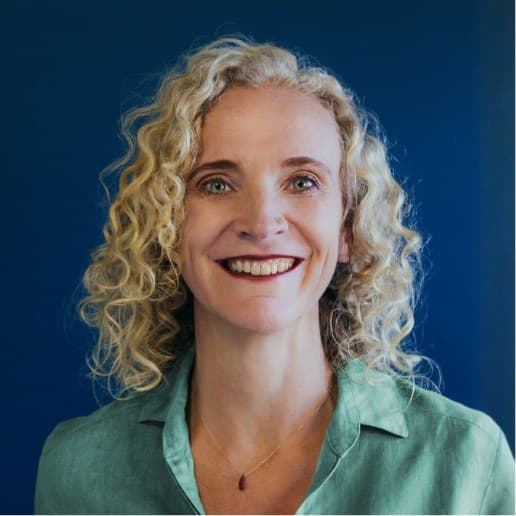Jolena Nicol, a smiling woman with curly fair hair in a green shirt